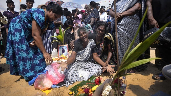 A Tamil woman cries for her deceased family members during a civil war remembrance in Mullivaikkal, Sri Lanka, May 17, 2024.