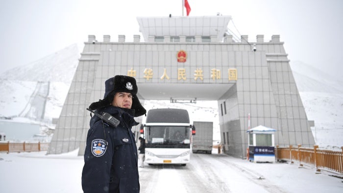 A Chinese police officer on a snowy road.