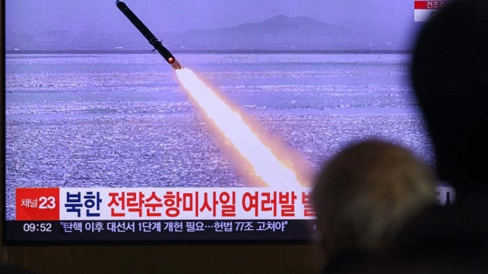 A TV shows a missile launch.