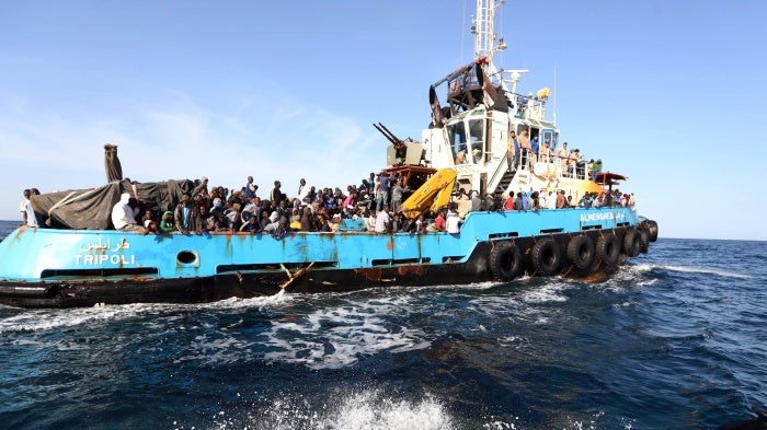 A Libyan coastguard boat carrying migrants arrive at the port in the city of Misrata on May 3, 2015, after the coastguard intercepted five boats carrying around 500 people trying to reach Europe.