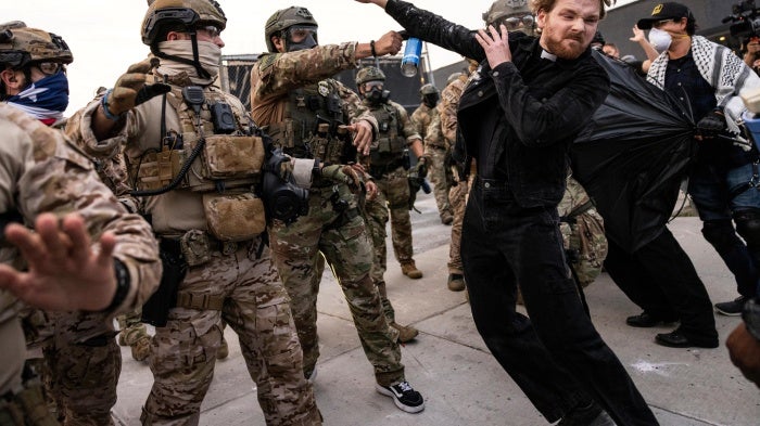 A federal immigration enforcement agent sprays Rev. David Black, of the First Presbyterian Church of Chicago, as he and other protesters demonstrate outside the US Immigration and Customs Enforcement facility in Broadview, Illinois, September 19, 2025.