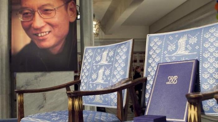 The Nobel certificate and medal is seen on the empty chair where this year's Nobel Peace Prize winner jailed Chinese dissident Liu Xiaobo would have sat, as a portrait of Liu is seen in the background, during the ceremony at Oslo City Hall December 10, 20