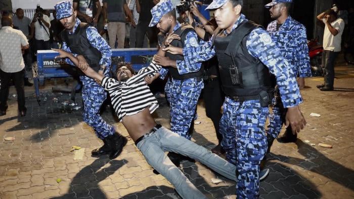 Police officers detain an opposition protester demanding the release of political prisoners during a demonstration in Malé, Maldives, February 2, 2018. 