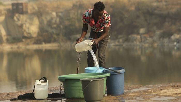 A man fetches water from a disused quarry in Harare, October 1, 2019. 