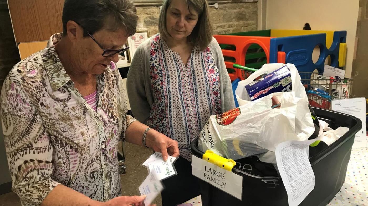 Volunteers at the Wisbech food bank, Cambridgeshire make up an emergency parcel suitable for a large family, April 20. This food bank can sometimes offer families with children an additional £5 voucher to be redeemed at the local butcher or greengrocers. 