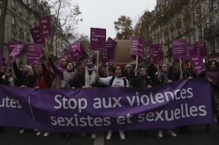 Women carry a banner reading "stop sexist and sexual violence " on November 20, 2021 in Paris.