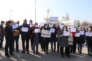 A group of people holding protest signs in Arabic