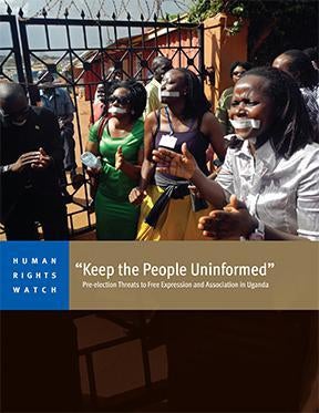 Employees of the Daily Monitor newspaper with their mouths taped shut, sing slogans during a protest against the closure of their premises by the Uganda government, outside their offices in the capital Kampala May 20, 2013. 