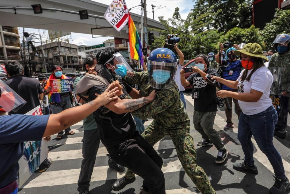 Police arrest protesters during a Pride march in Manila, Philippines, June 26, 2020.