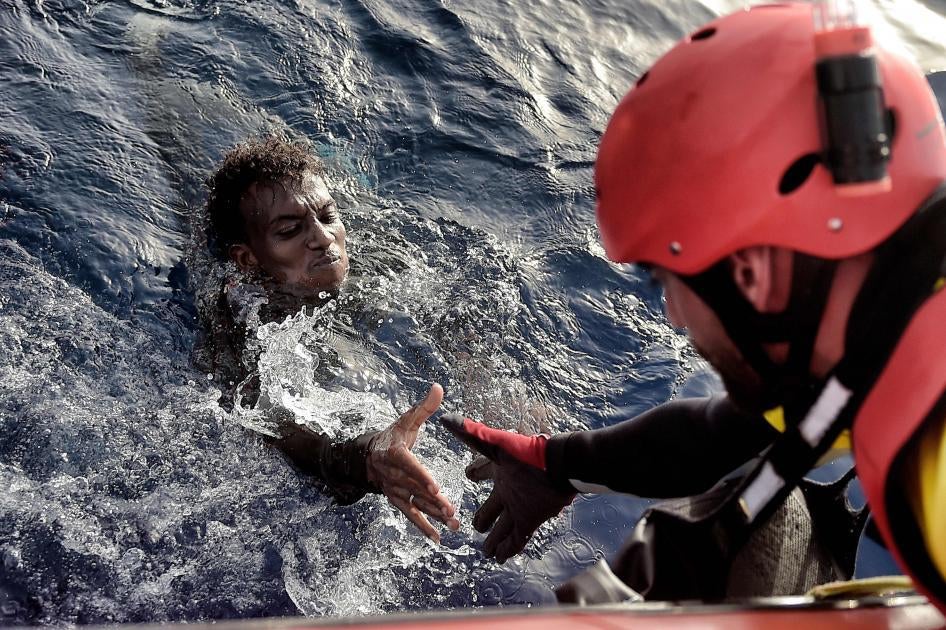 A man is rescued from the Mediterranean Sea by a member of Proactiva Open Arms NGO some 20 nautical miles north of Libya on October 3, 2016.  © 2016 Getty Images
