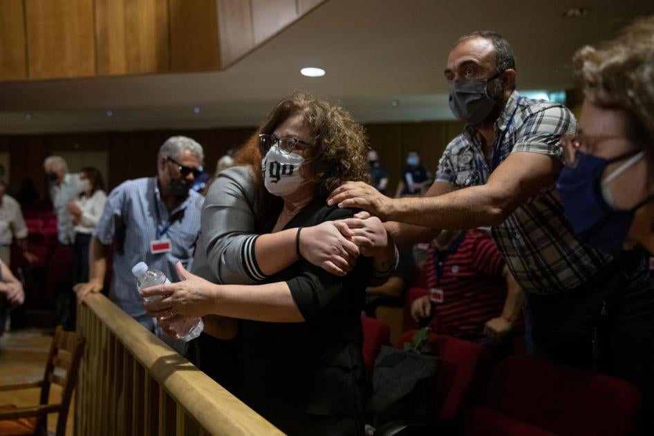Magda Fyssa, the mother of late Greek rap singer Pavlos Fyssas, who was stabbed and killed by a supporter of the extreme right Golden Dawn party in 2013, celebrates immediately after the delivery of the verdict in Athens, October 7, 2020. 