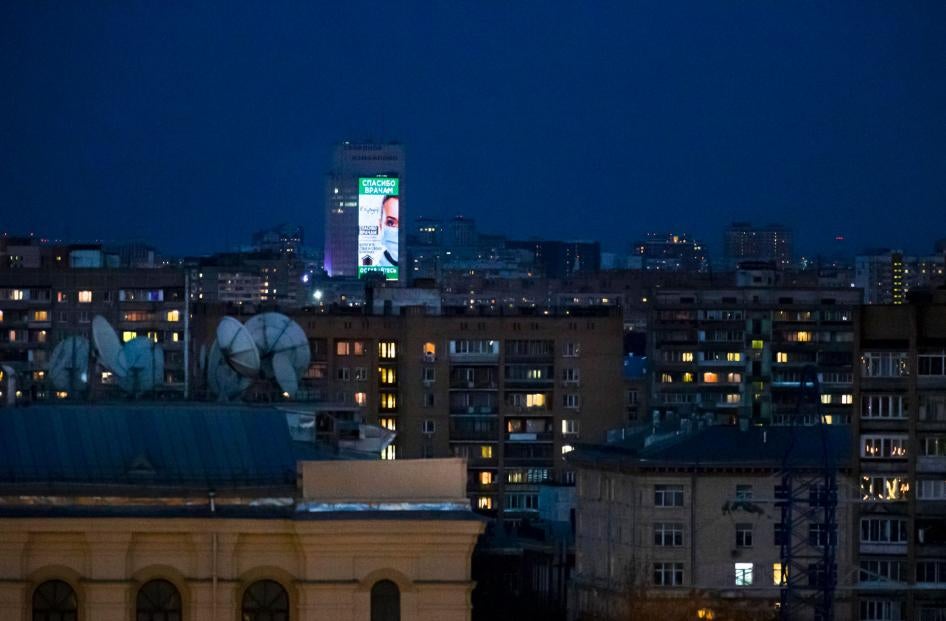 An electronic billboard  is displayed on a office building after sunset in Moscow, Russia, April, 11, 2020. 