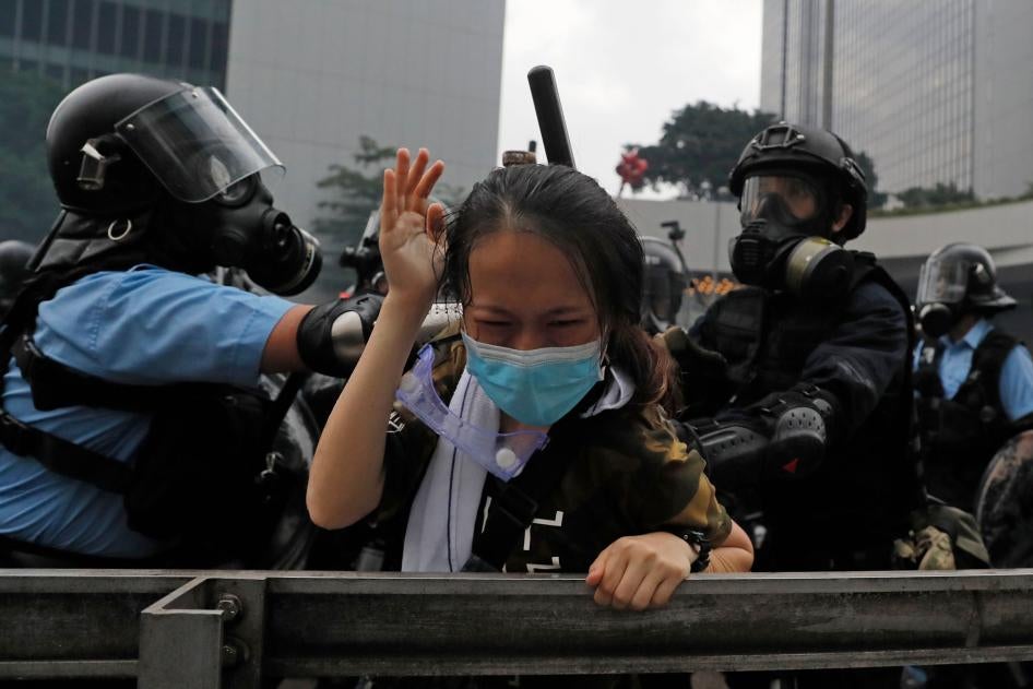 A protester is tackled by riot police during a demonstration outside the Legislative Council in Hong Kong, June 12, 2019.