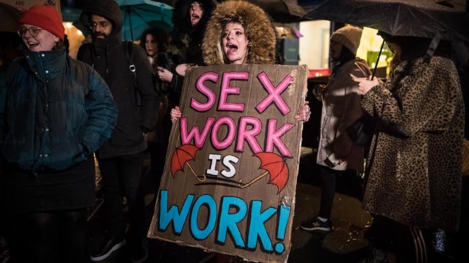 People take part in an International Women's Day march in London, England, against criminalization of sex work