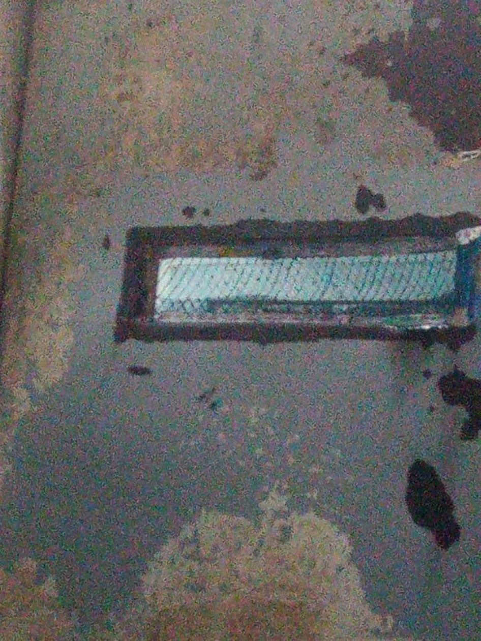 A leaked photo showing the metal door of a Scorpion cell with a small slit in the door, before the recent changes.