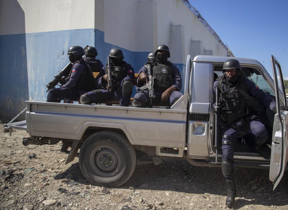 Heavily armed police are part of the group delivering Supreme Court justice Yvickel Dabrésil along with other detained individuals into custody at the penitentiary in Croix-des-Bouquets, Haiti, Feb. 9, 2021.