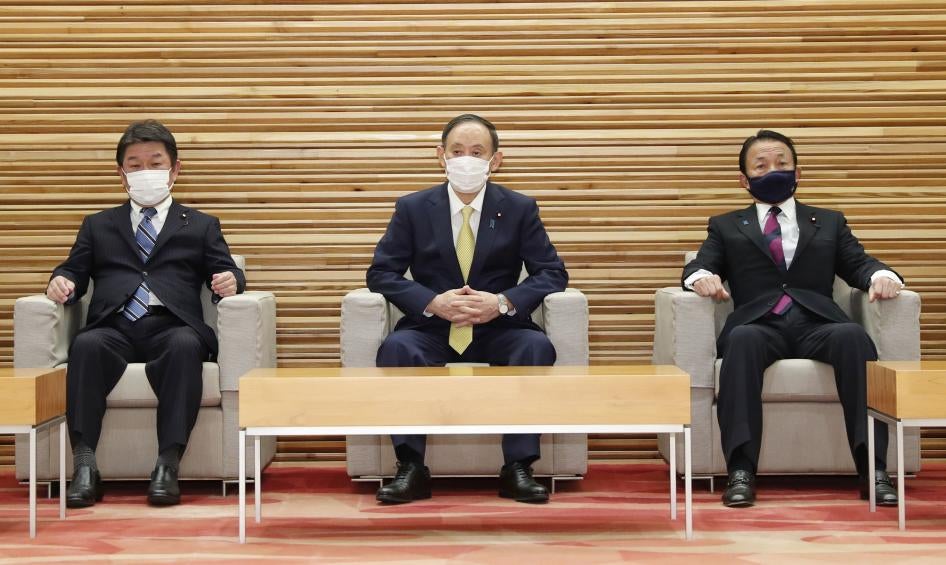 Japanese Foreign Minister Toshimitsu Motegi (left), Prime Minister Yoshihide Suga (center), and Finance Minister Taro Aso (right) attend a Cabinet meeting in Tokyo on February 24, 2021.
