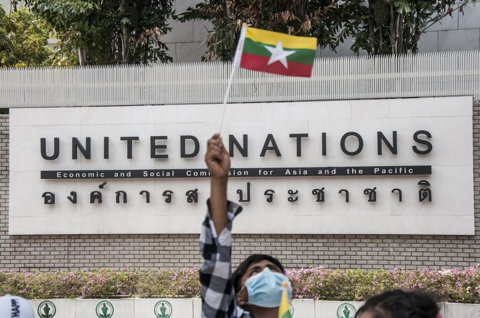 A protester waving a Myanmar nation flag in front of the United Nation building during the demonstration.