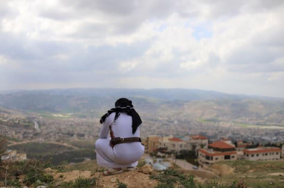 A Yemeni asylum seeker who arrived in Jordan in 2014, overlooks the city in the neighborhood of Abu Nseir, North of Amman, Jordan on March 25, 2021.