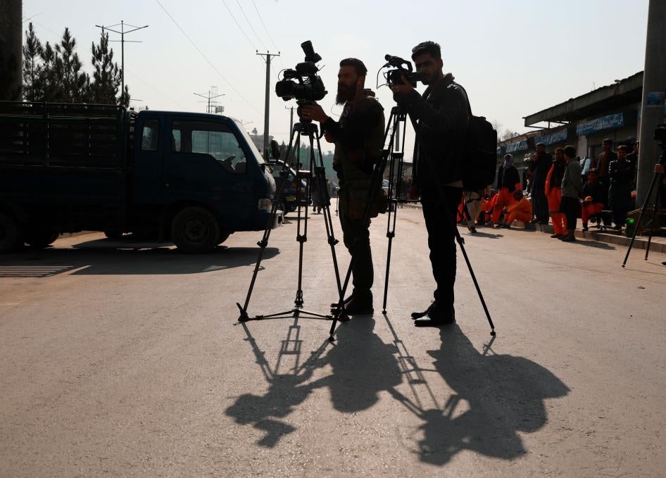 Afghan journalists film at the site of a bombing attack in Kabul, Afghanistan, Tuesday, Feb. 9, 2021. 