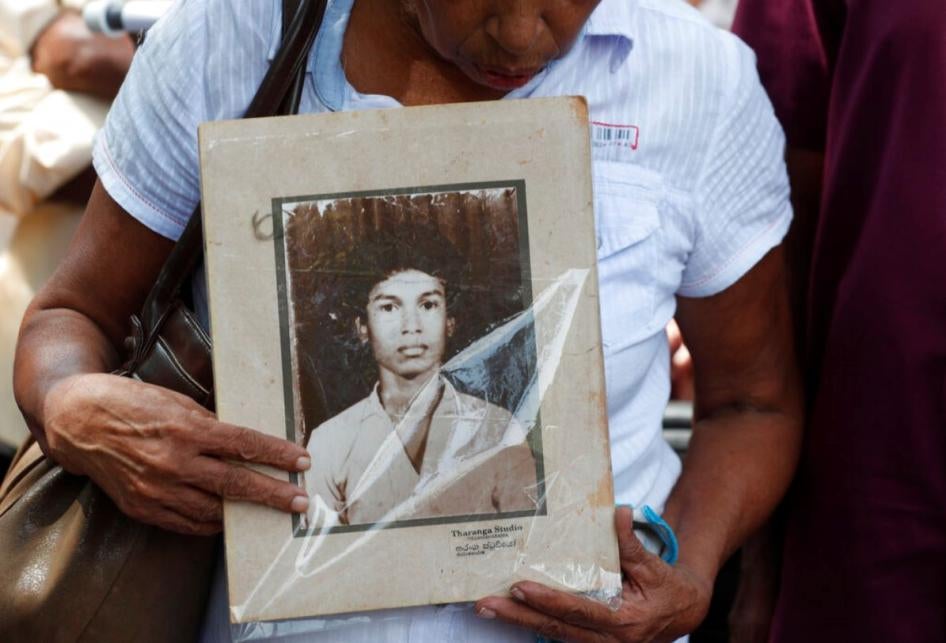 A Sri Lankan woman holds a portrait of a relative who went missing, during a protest in Colombo, Sri Lanka,  February 14, 2020.