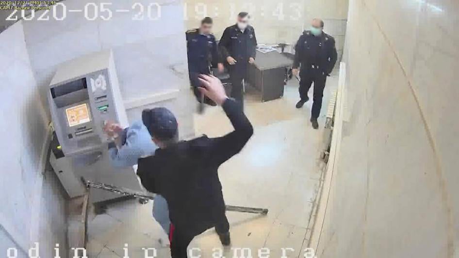 In this undated frame grab taken from video shared with The Associated Press by a self-identified hacker group called "The Justice of Ali," a guard hits a prisoner, at Evin prison in Tehran, Iran. 