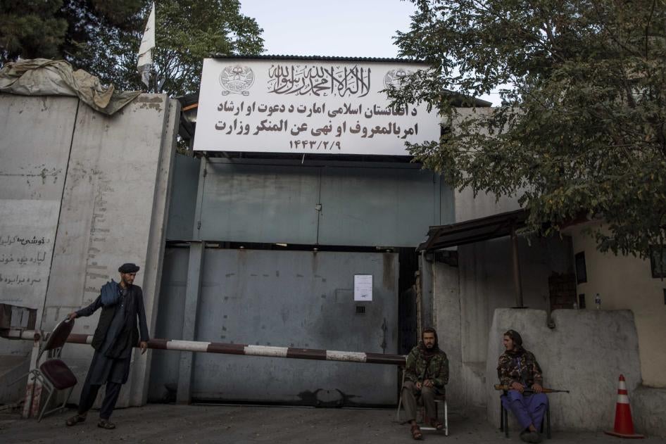 Taliban fighters stand guard at the entrance to the former Ministry of Women Affairs, which the Taliban has replaced with the Ministry of Vice and Virtue, which oversees the implementation of hardline Islamic rules in Afghanistan.