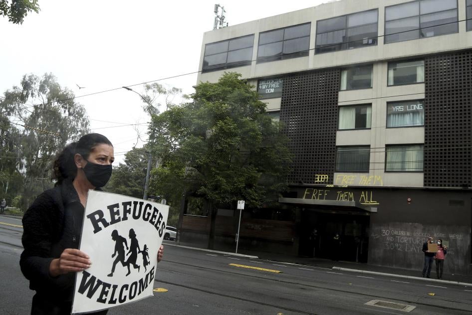 A protester outside the Park Hotel calling for the release of refugees being detained inside the hotel in Melbourne