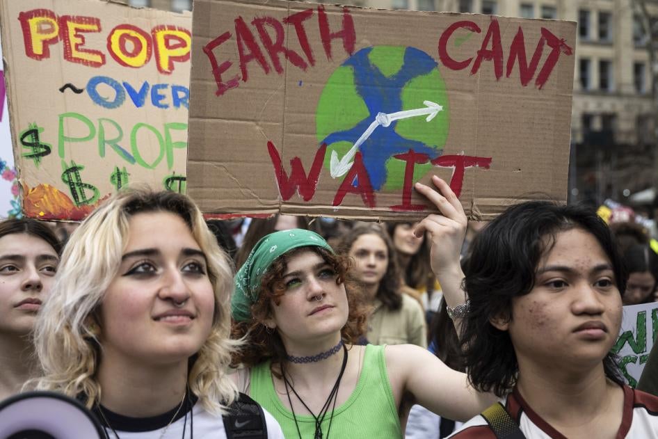 People at a protest holding handmade signs