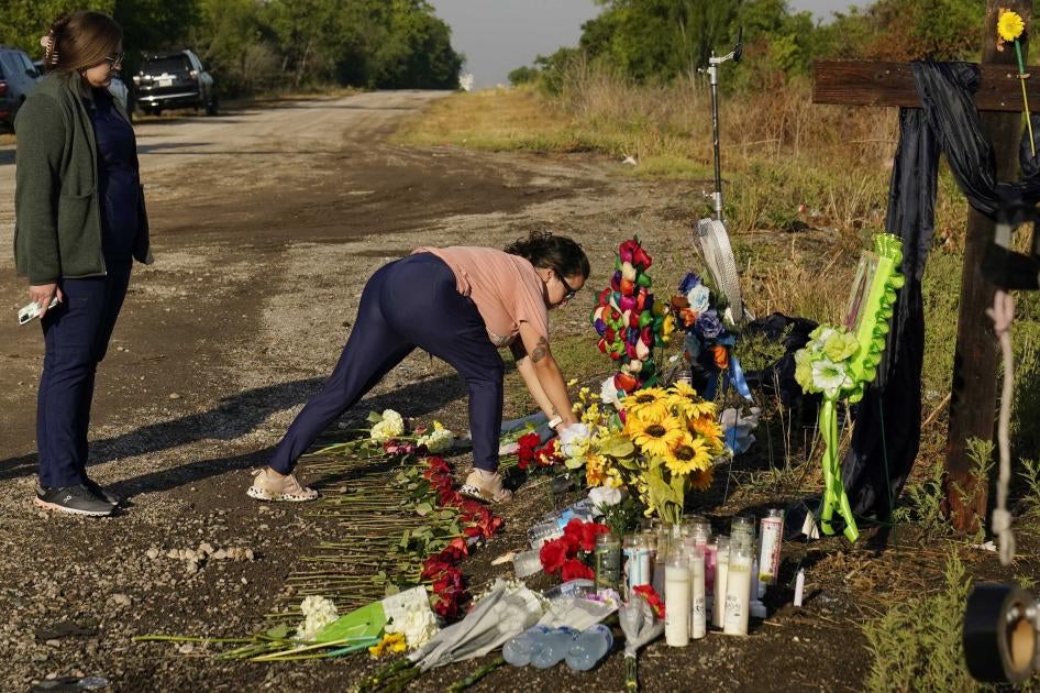 Mourners lay flowers at a makeshift memorial