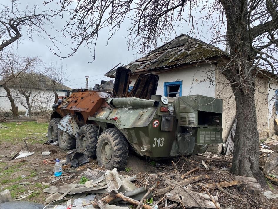 An abandoned Russian armored vehicle parked next to a home in Yahidne village, April 17, 2022. 