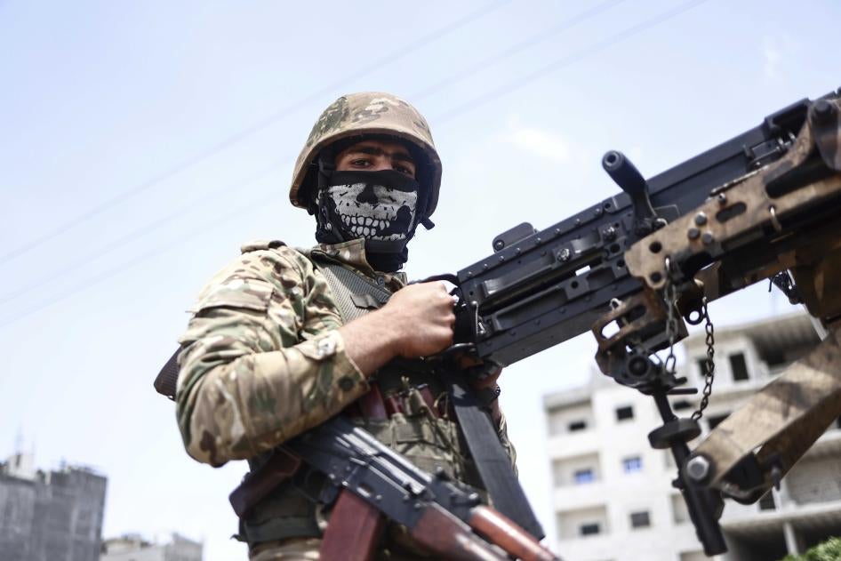 A fighter of the Turkish-backed Syrian National Army take part in a military parade in the countryside of Aleppo Governorate on June 9, 2022, as part of the forces' preparations for military actions on the areas controlled by the Syrian Democratic Forces.