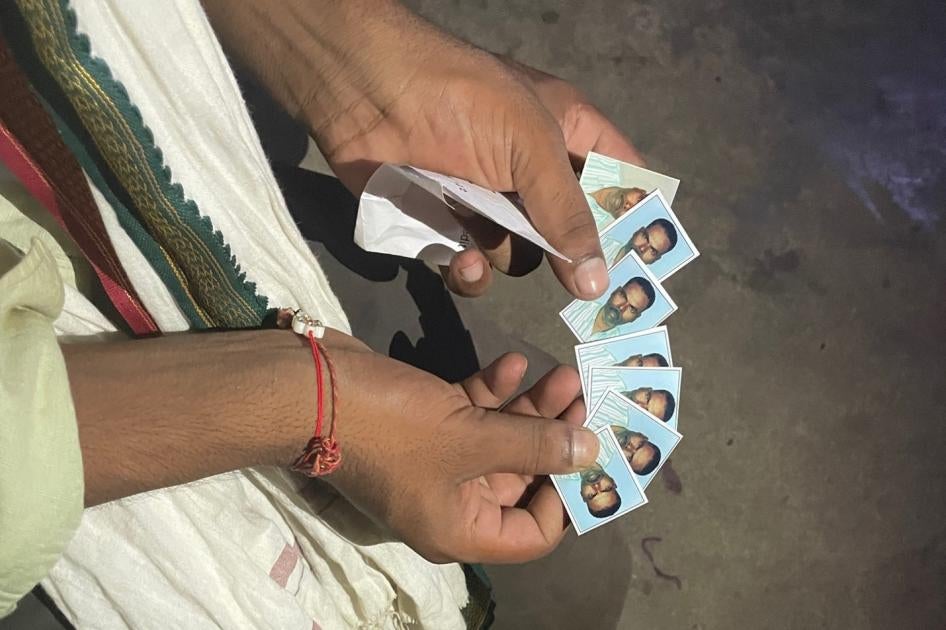 Son showing photos of father who died in Qatar