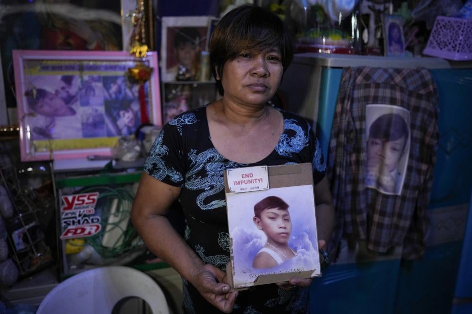 Mother holding a photo of her deceased son.