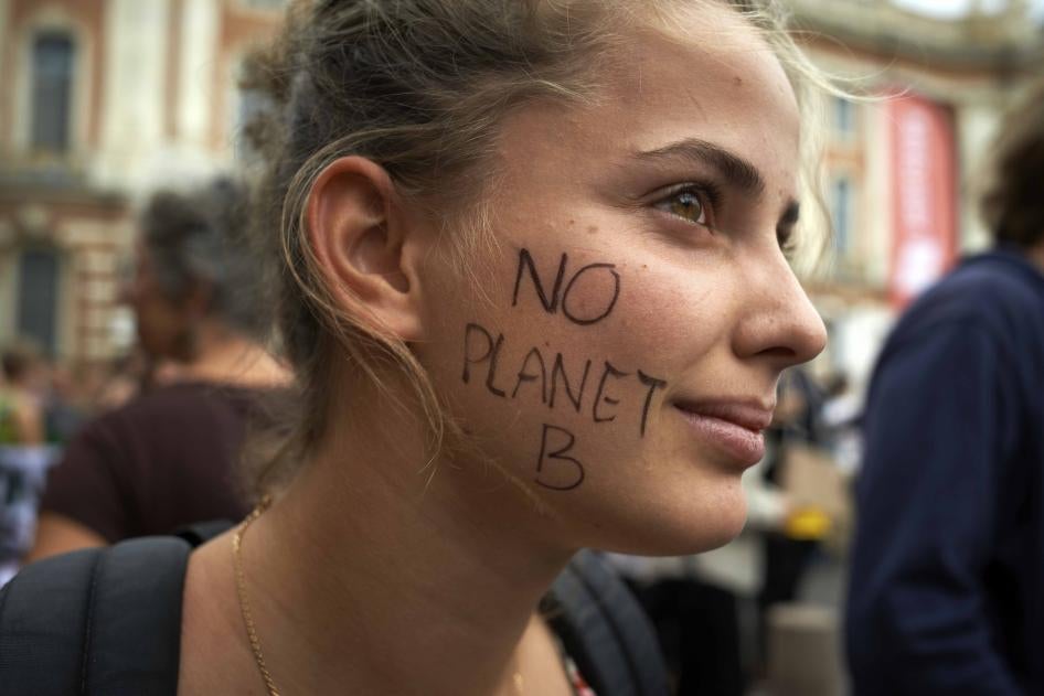 A protester with "NO PLANET B" written on her face attends a climate change demonstration in Toulouse, France, September 23, 2022.