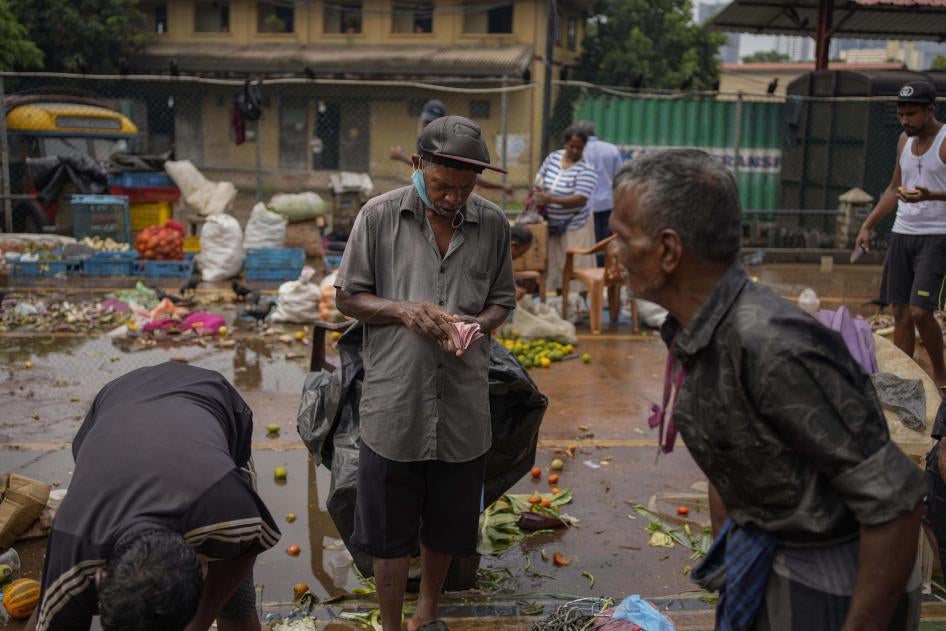 A man counts money at a marketplace in Colombo, Sri Lanka