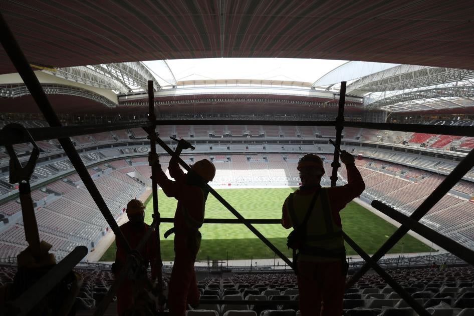 Laborers remove scaffolding at the Al Bayt stadium in Al Khor, Qatar, Monday, April 29, 2019.