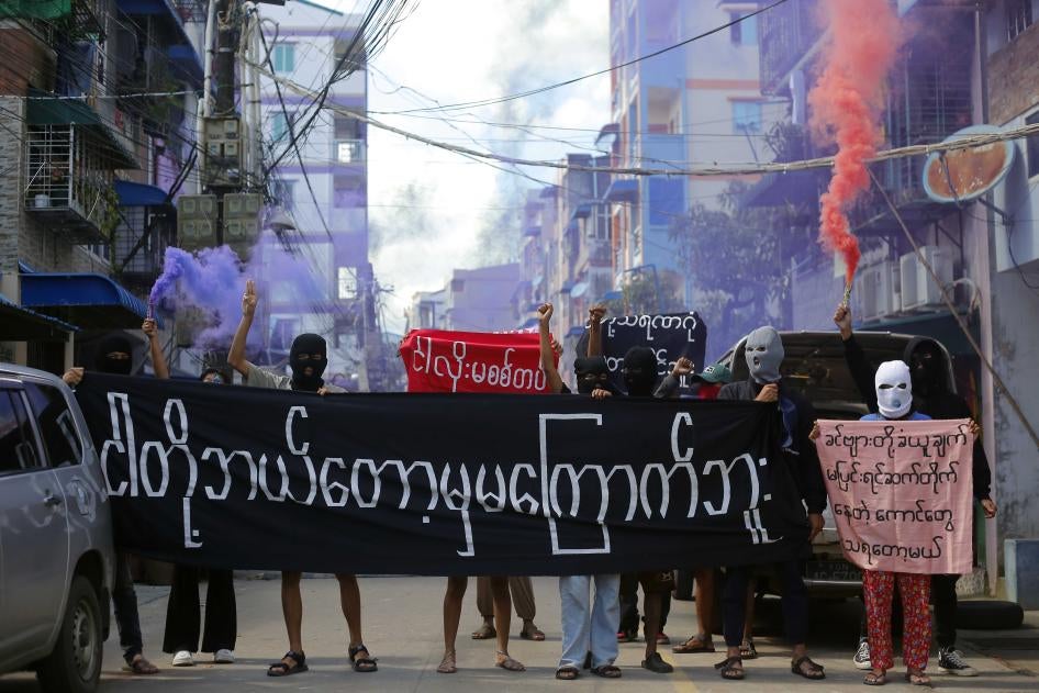 Protesters hold a banner reading “We will never be frightened,” in Yangon, Myanmar