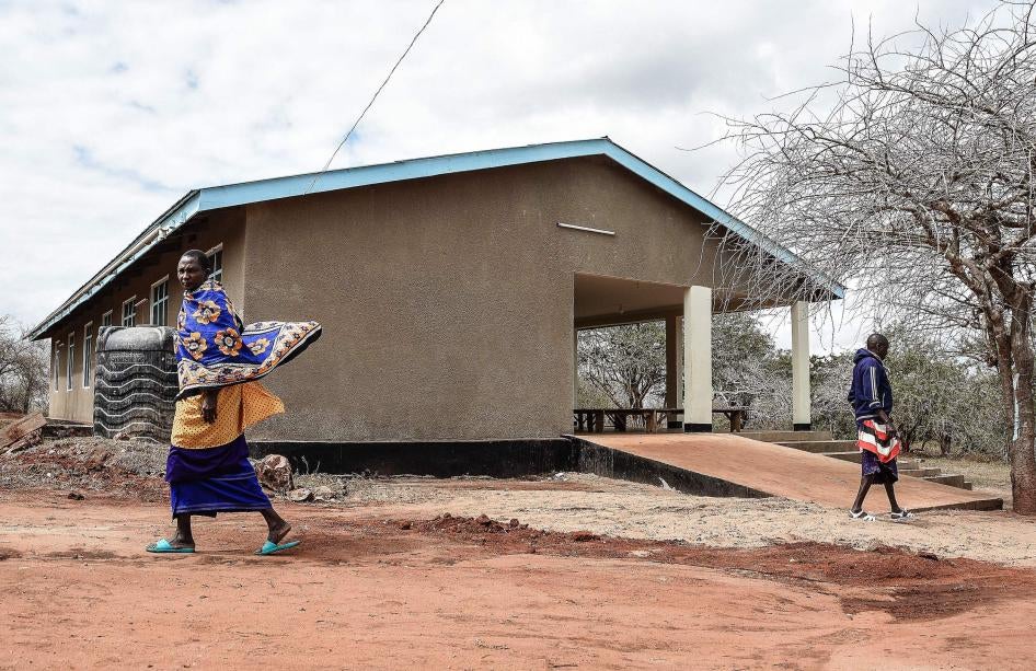 Maasai people walk past the health facility in Msomera village, Handeni, Tanzania.