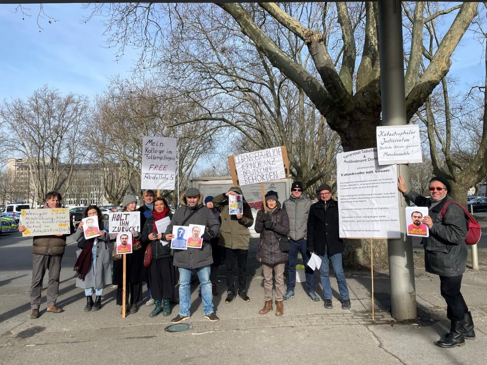 Supporters of Tajik activist Abdullohi Shamsiddin, in Dortmund, Germany, hold posters