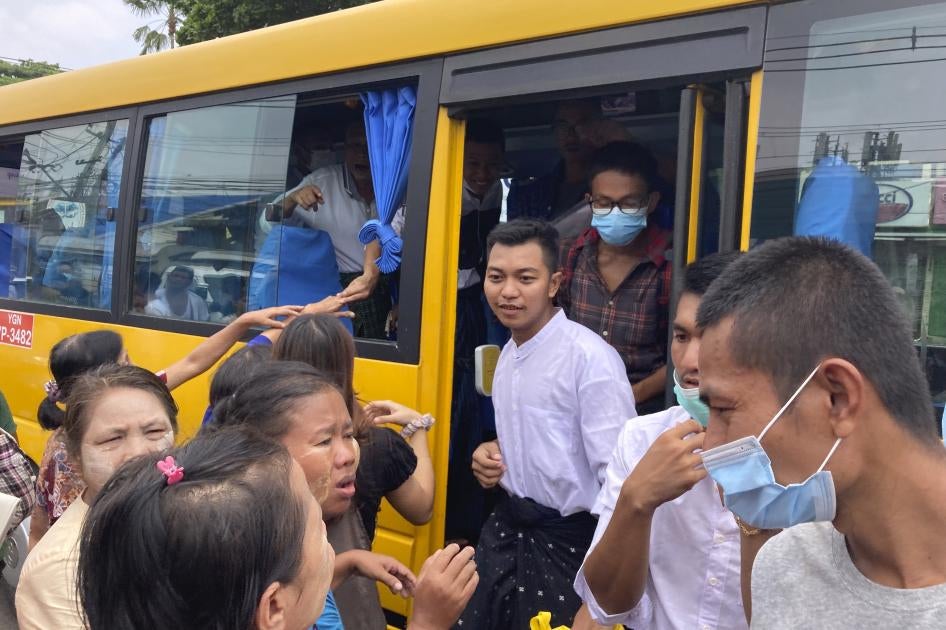 Prisoners get off a bus after their release from Insein Prison