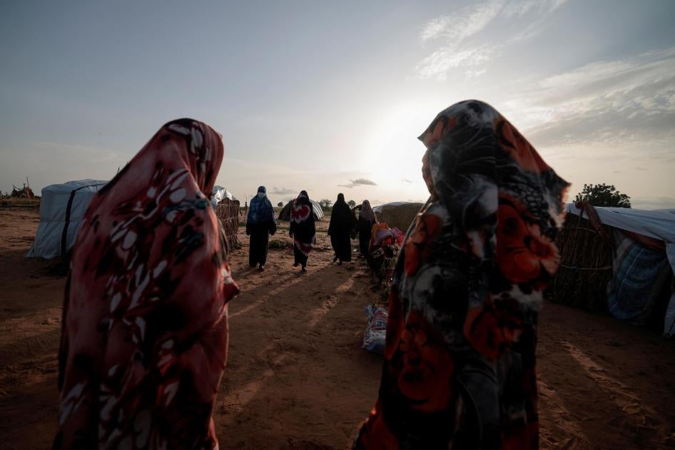  Survivors of sexual violence, who fled the fighting in El Geneina, in Sudan’s Darfur region, outside their makeshift shelters in Adre, Chad, August 1, 2023. © 2023 REUTERS/Zohra Bensemra