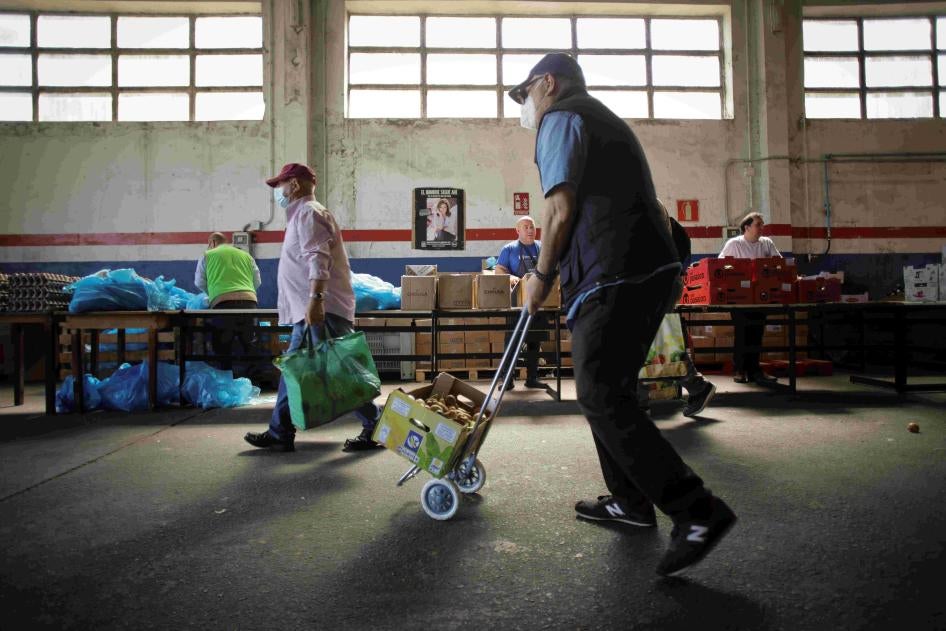 Volunteers attend to people at the Food Bank of Lugo, May 2, 2023, in Lugo, Galicia, Spain.