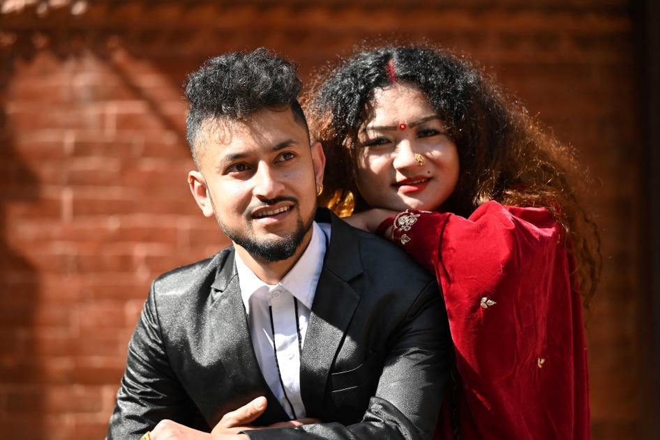 An LGBTQ couple, Surendra Pandey (left) and Maya Gurung, a transgender woman, pose for pictures after obtaining their marriage certificate in Kathmandu, Nepal, December 1, 2023.