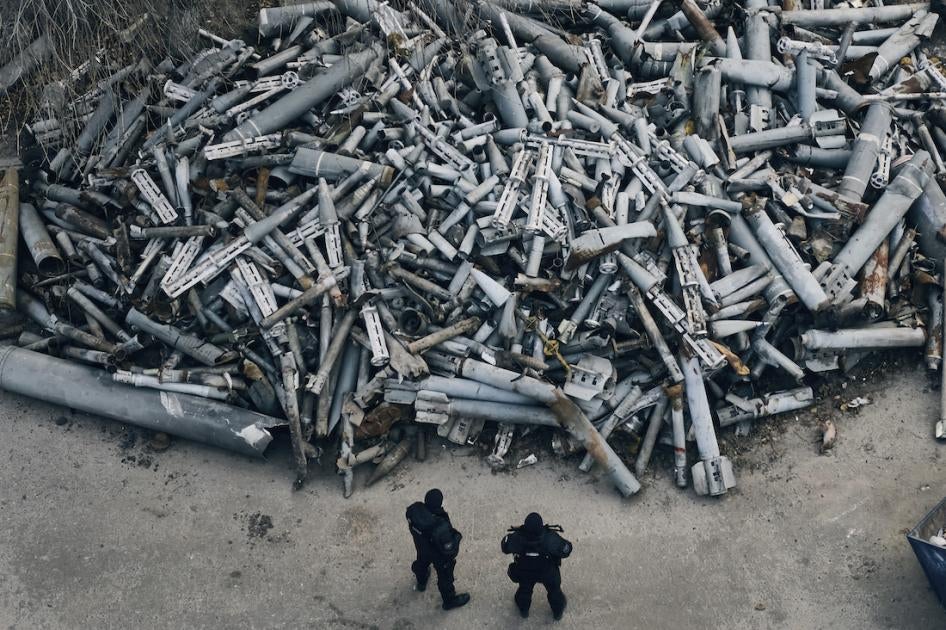 Ukrainian police officers look at collected fragments of rockets, including cluster rounds, that hit Kharkiv, in Kharkiv, Ukraine, December 3, 2022. 