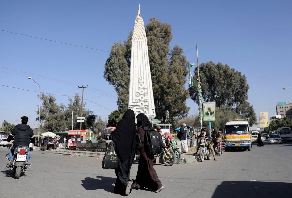 Women walk at the “Change Square” outside Sanaa University’s gate, Sanaa, Yemen. 