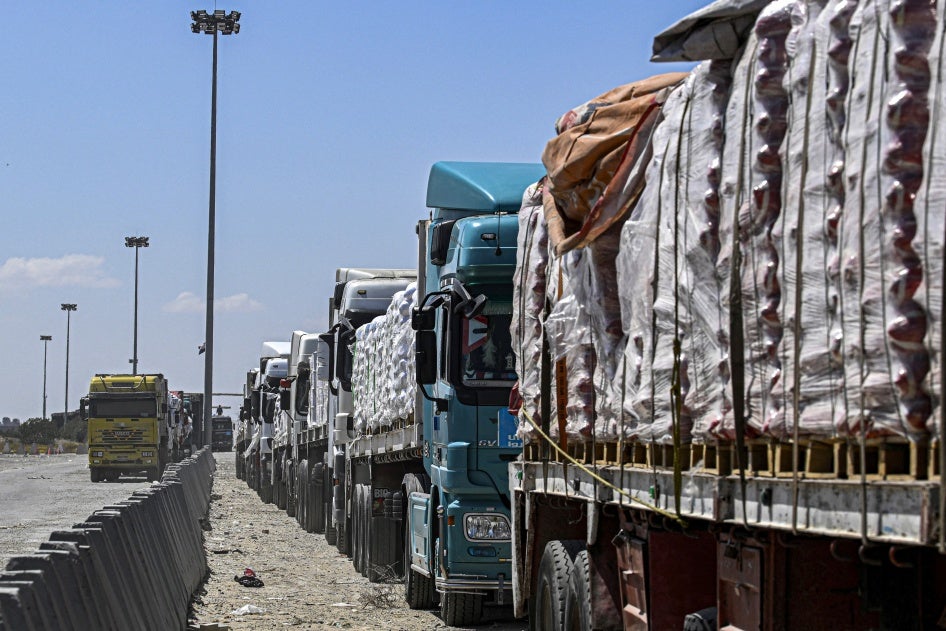  Egyptian trucks carrying humanitarian aid bound for the Gaza Strip queue outside the Rafah border crossing on the Egyptian side on March 23, 2024. 