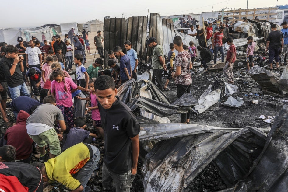 Palestinians inspect their destroyed tents after an Israeli air strike