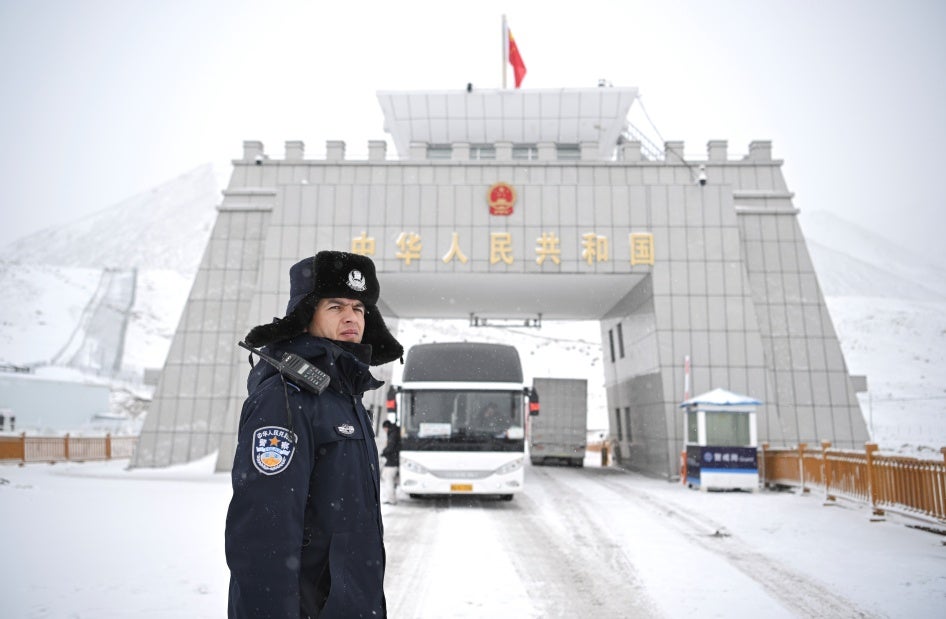 A Chinese police officer on a snowy road.