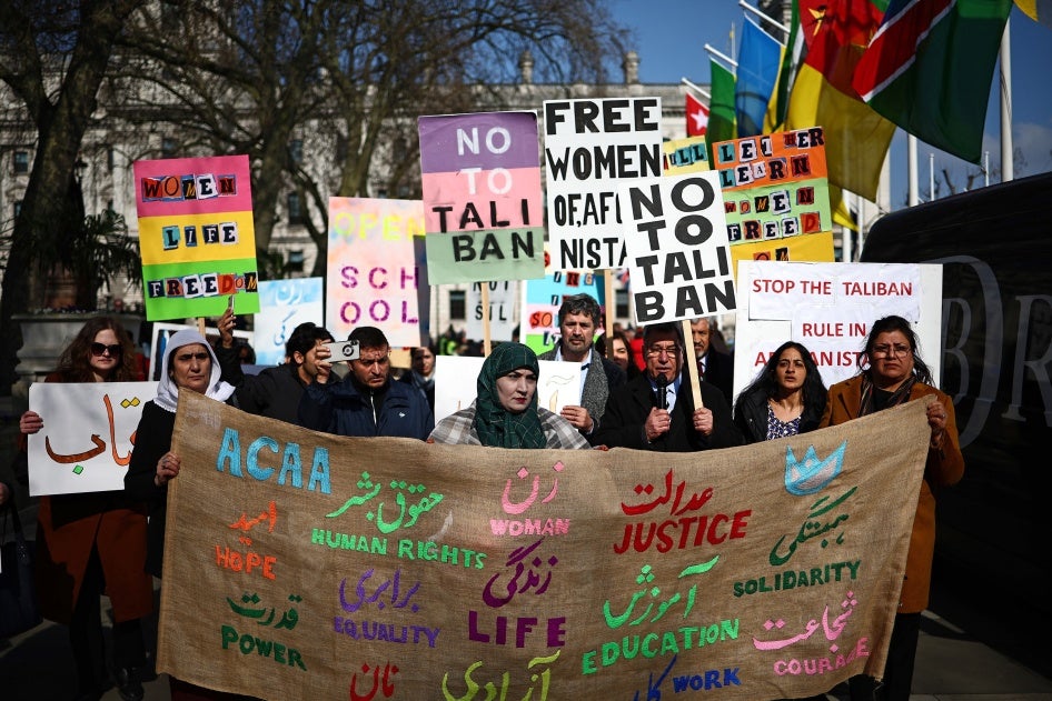 Protesters hold placards at a demonstration calling for women's rights in Afghanistan